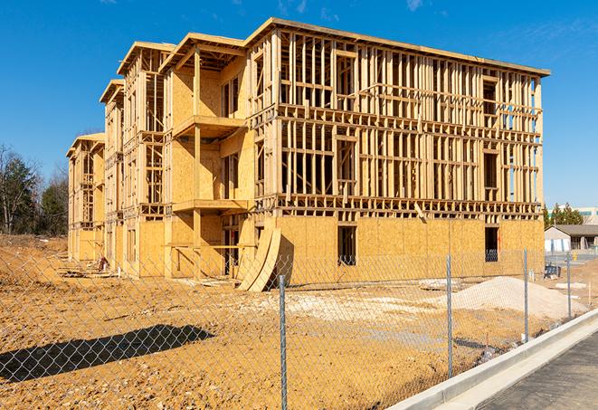 workers protected by temporary barrier fence during building maintenance in Dixon Springs